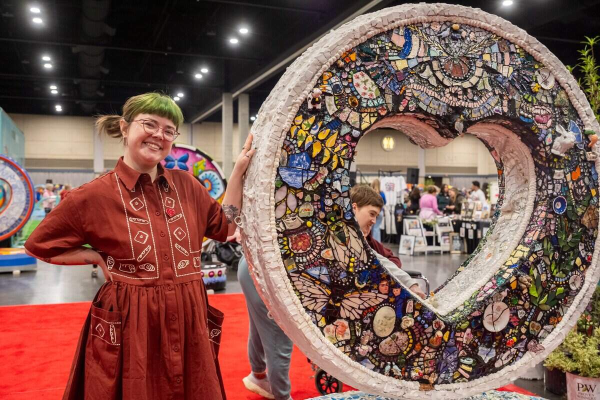 Artist Miranda Pietzsch stands next to her heart titled “bits & pieces” during the first public exhibition of the new Parade of Hearts sculptures on Saturday, April 4, 2026, in Overland Park. Pietzsch created a mosaic using found pieces from estate sales around the city.