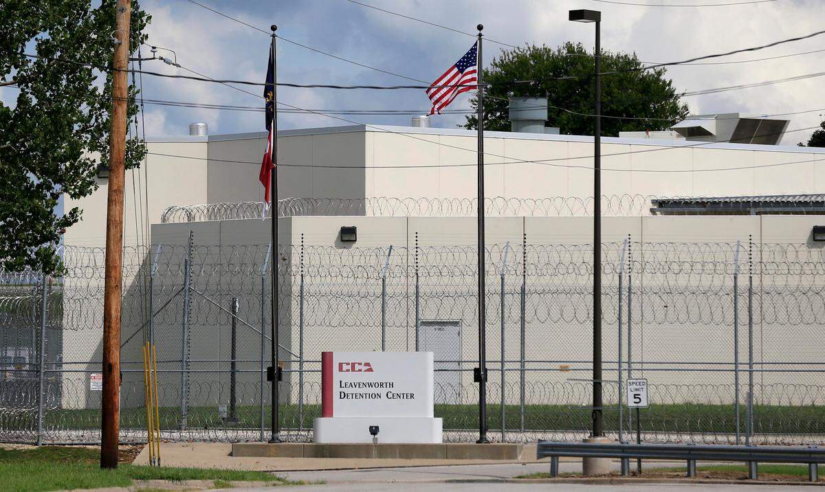 FILE - This 2016 file photo shows the main gate of the Leavenworth Detention Center. The center, operated by private prison company CoreCivic, has been the site of two suicides and at least 10 severe beatings and stabbings this year, according to attorneys representing inmates there. (AP Photo/Orlin Wagner File)