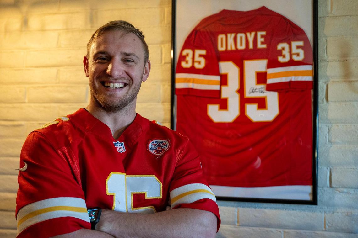 Philip Rineberg, a Kansas City Chiefs fan, displays a framed signed jersey from former Kansas City Chiefs running back Christian Okoye at his home on Monday, Feb. 5, 2024, in Guymon, Okla.