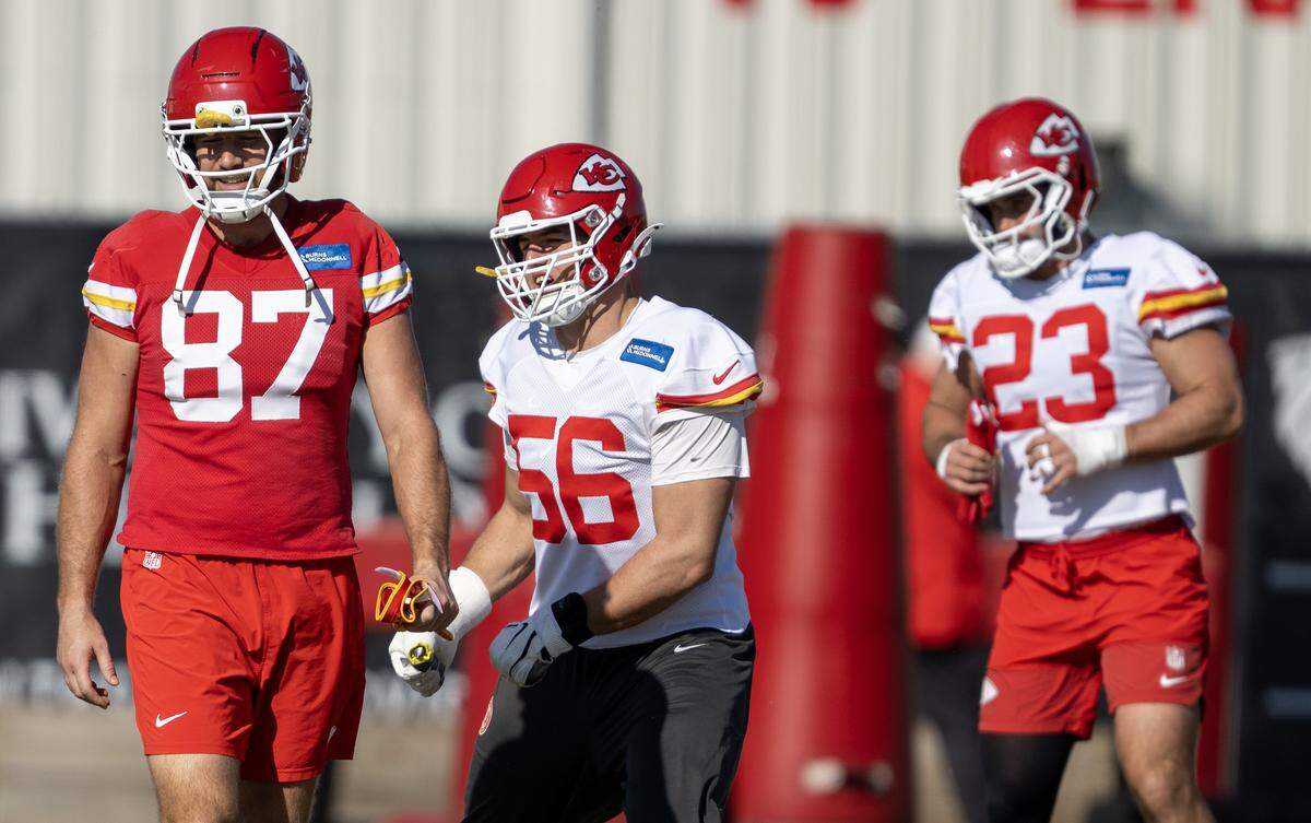 Kansas City Chiefs tight end Travis Kelce (87), defensive end George Karlaftis (56) and linebacker Drue Tranquill (23) loosen up during practice at the team's training facility on Friday, November 14, 2025, in Kansas City.