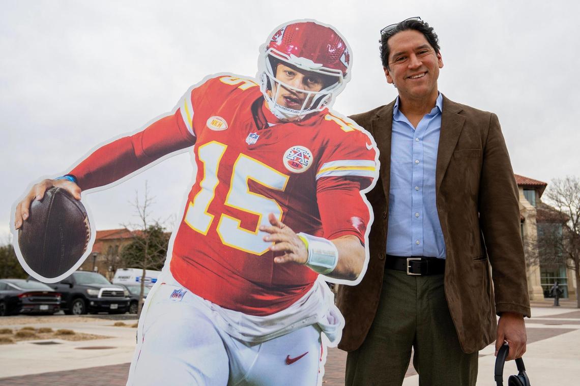Jesse Mendez, a professor of education, poses for a photo next to a life-size cutout featuring Kansas City Chiefs quarterback Patrick Mahomes on Tuesday, Feb. 6, 2024, at Texas Tech University in Lubbock, Texas.