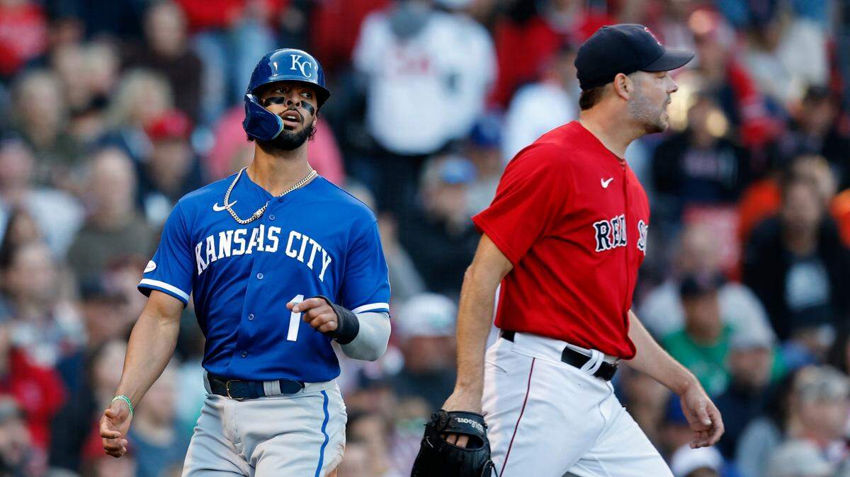 Kansas City Royals’ MJ Melendez (left) looks back after scoring on an RBI single by Bobby Witt Jr., off Boston Red Sox’s Rich Hill (right) during the fifth inning on Saturday, Sept. 17, 2022, in Boston.