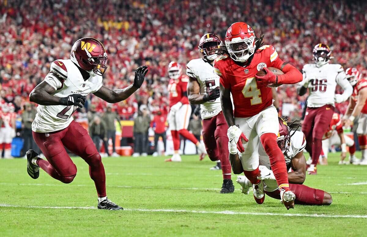 Kansas City Chiefs wide receiver Rashee Rice (4) runs pas the defense of Washington Commanders safety Tyler Owens (18) and safety Quan Martin (20) to score a touchdown in the fourth quarter on Monday, Oct. 27, 2025, at GEHA Field at Arrowhead Stadium.