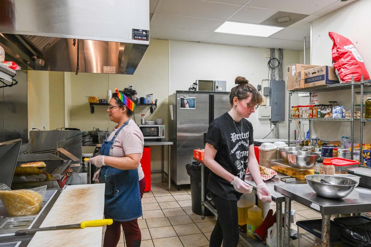 Staff members Angela Randazzo and Haley Mullenix prepare meals at Tree Hugger in Riverside on Monday, June 9. Co-owner Phil Newman says the spacious kitchen is a big change from the cramped space of the food truck.