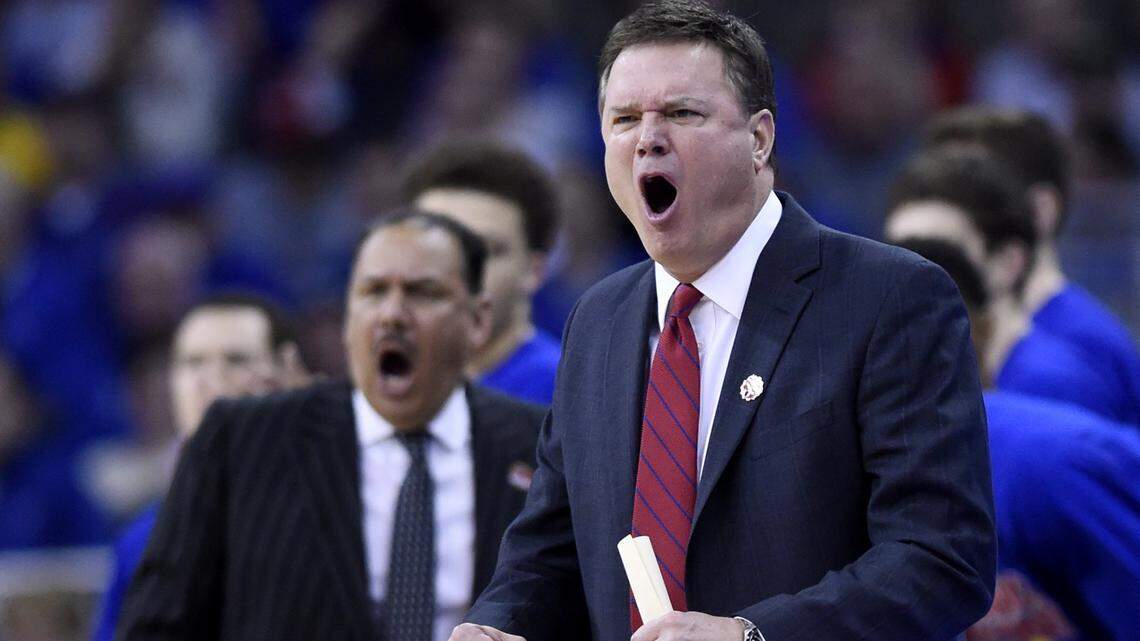 Kansas coach Bill Self (right) and assistant Kurtis Townsend weren’t in Austin for the football team’s upset of Texas Saturday, but they kept up with the game.