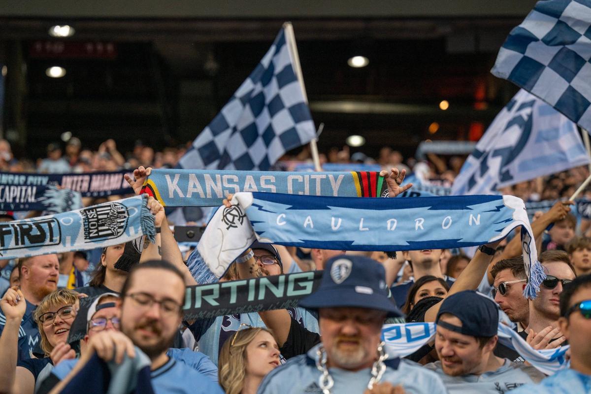 Fans hold up scarfs during an MLS game between Sporting Kansas City and Inter Miami at GEHA Field at Arrowhead Stadium on Saturday, April 13, 2024, in Kansas City.