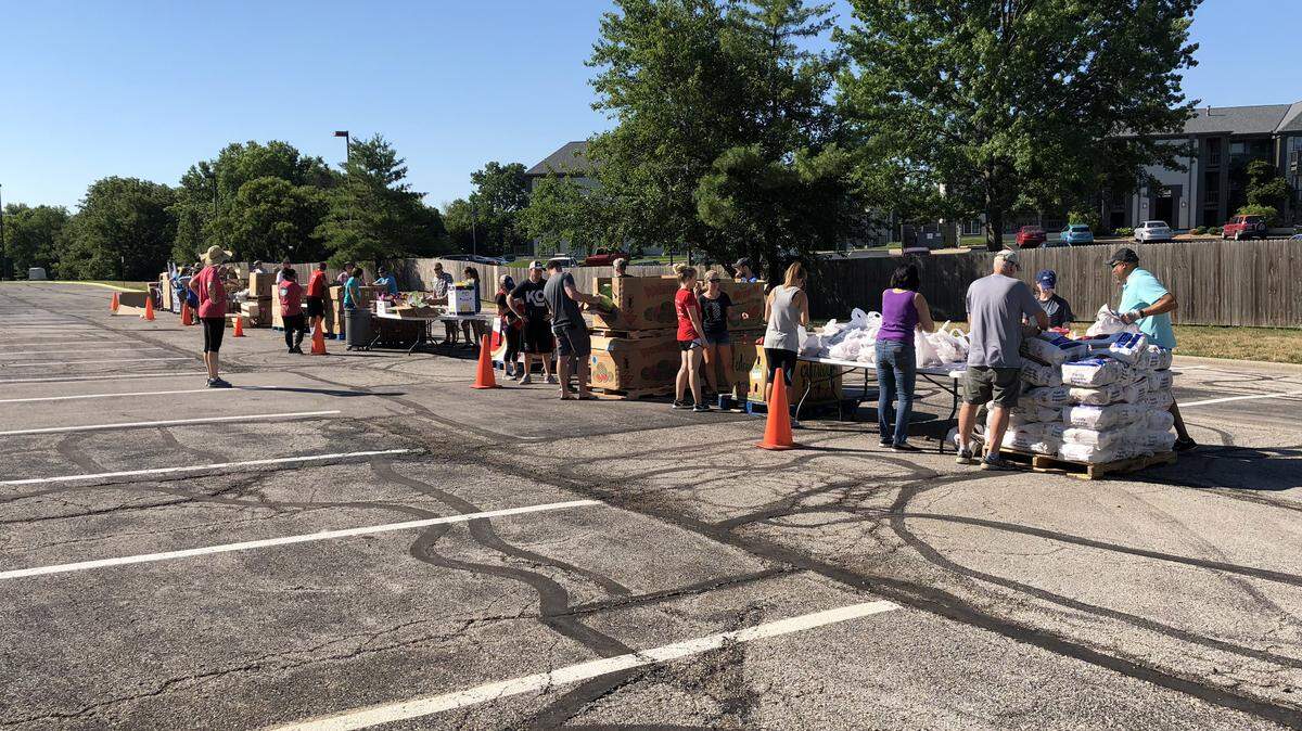 Harvesters volunteers ready pallets at a mobile food pantry. Volunteer work may be something that gets a boost, even after the pandemic lets up. 