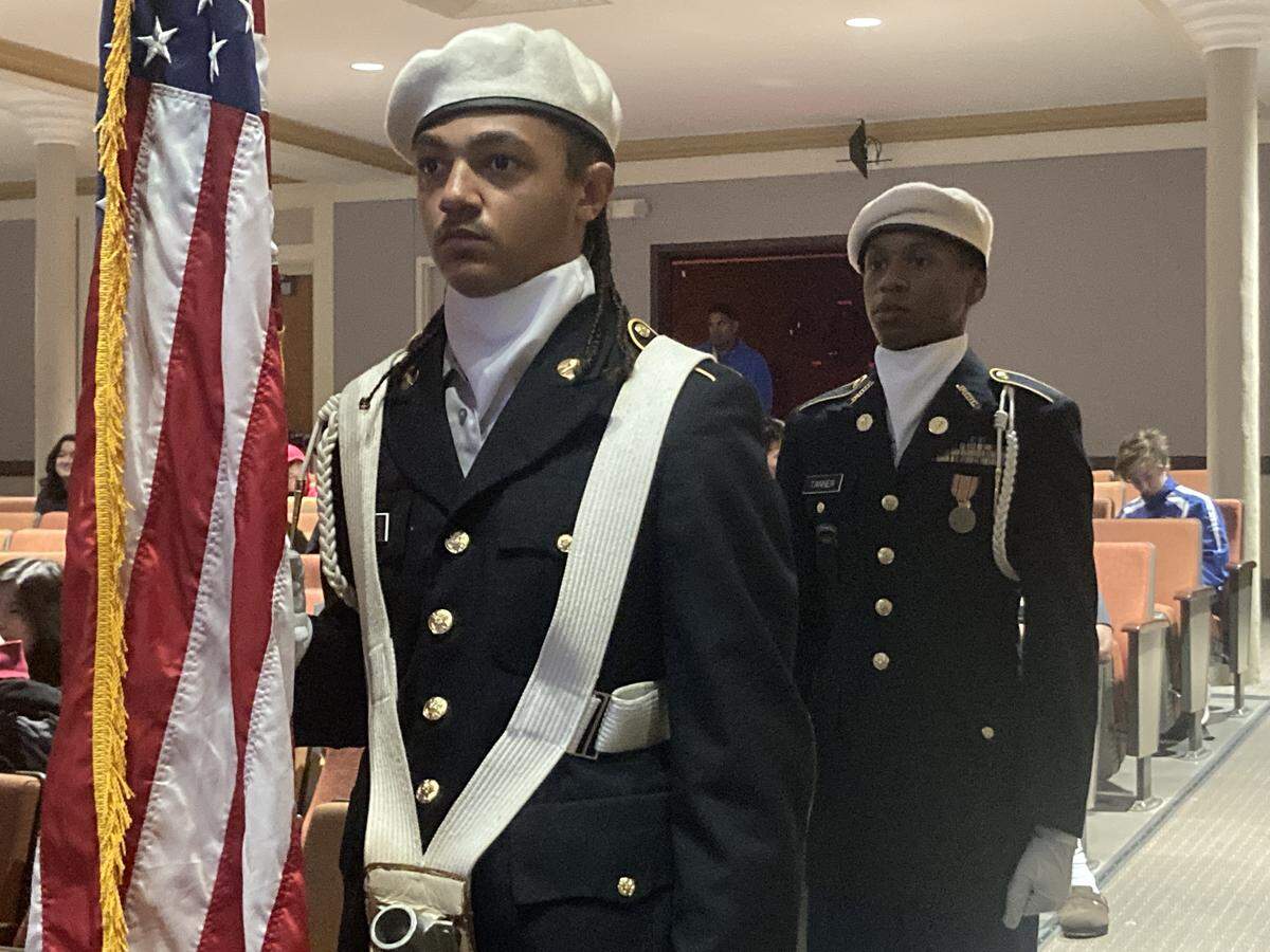 The Lincoln College Preparatory Academy color guard stands at attention prior to an event, awarding an honorary high school diploma to alumnus Pfc. Willy F. James, Jr., recipient of the Medal of Honor.
