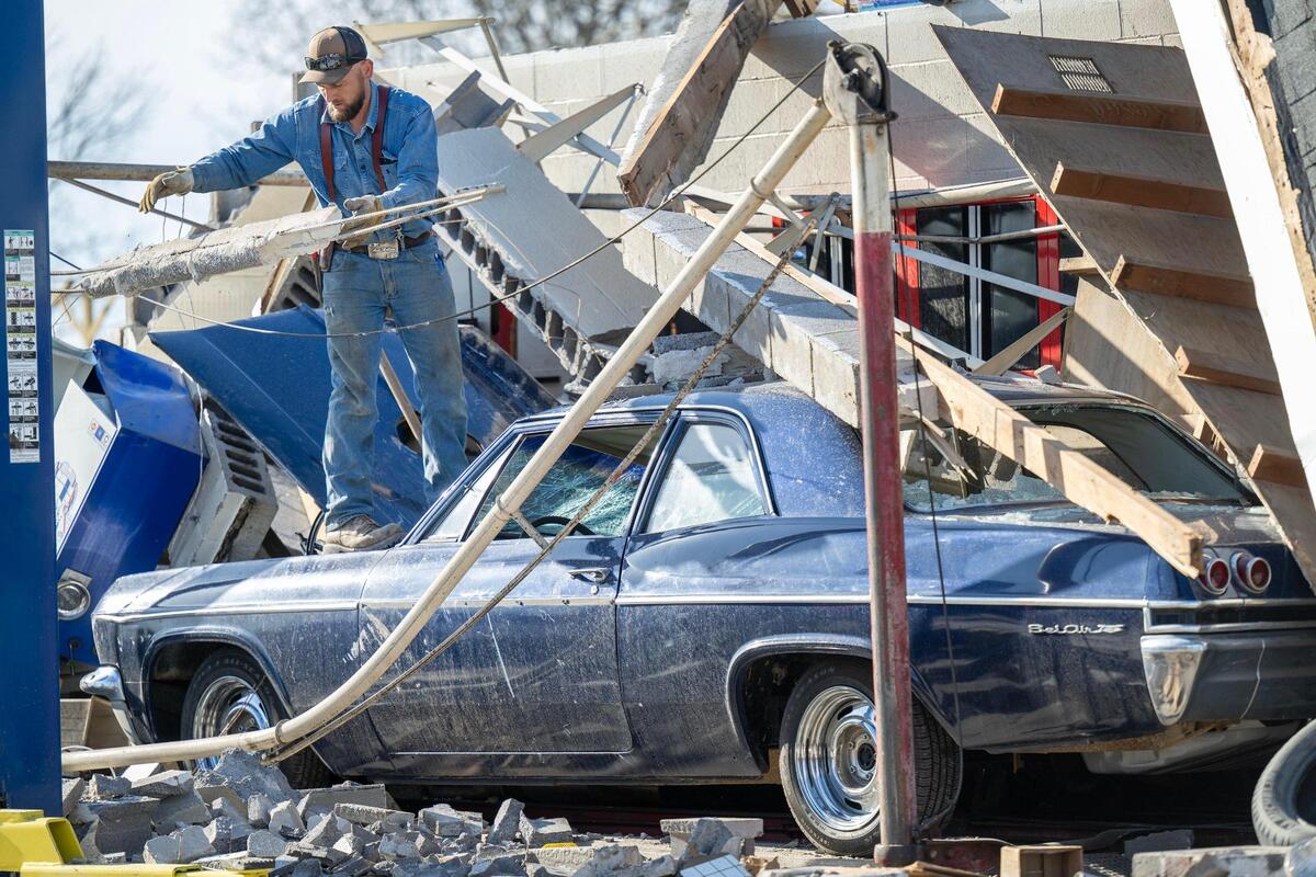 Austin Potthast of Liberal, Missouri, was one of those who showed up to help out after the Moundville Service Station which was destroyed by a tornado on Wednesday. Potthast worked to remove debris from atop a classic, 1965 Chevrolet Bel Air.