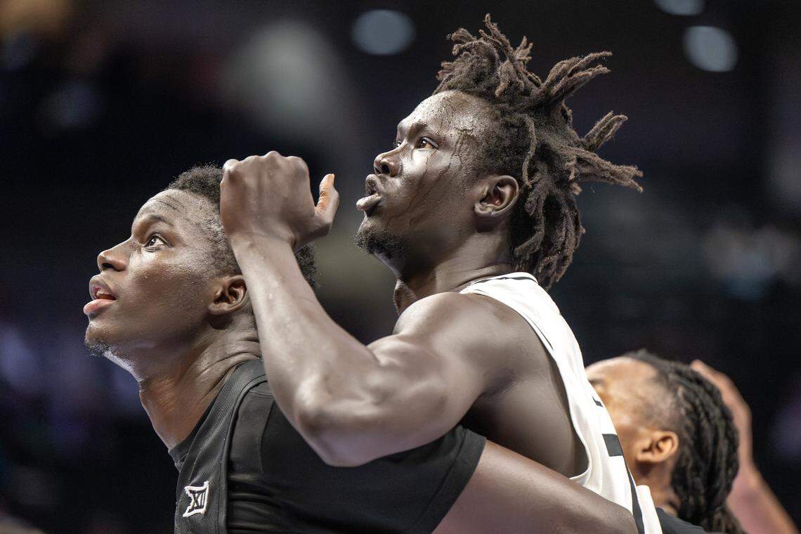 Cincinnati Bearcats center Moustapha Thiam (52), left, and UCF Knights center John Bol (7) battle for a rebound during the second half of a Big 12 Men's Basketball Tournament game at T-Mobile Center on Wednesday, March 11, 2026, in Kansas City.