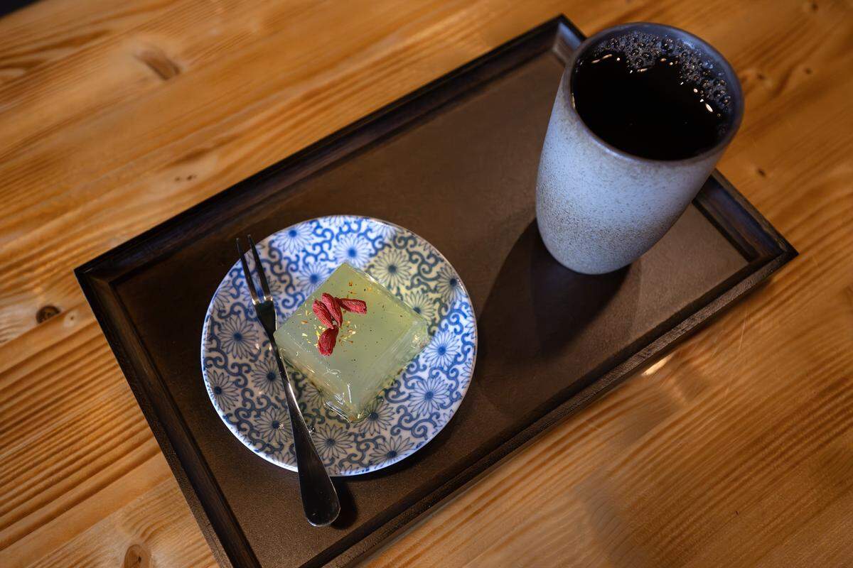 Green tea is served alongside a translucent jelly dessert at Moon Bar KC on Tuesday, Dec. 16, 2025, in Kansas City.
