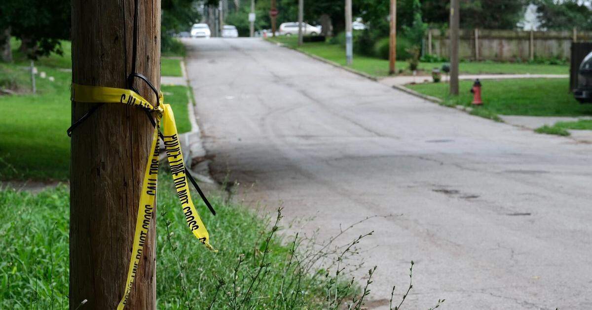 Yellow crime scene tape hung from a utility on the street were a man died in an early morning shooting Tuesday. The victim was struck by gunfire that came from outside a home in the 6000 block of Indiana Avenue, which is just east of the Bruce R. Watkins Drive in the South Town Fork Creek neighborhood in Kansas City.