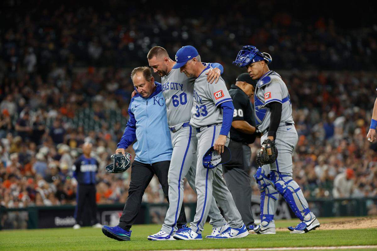 Kansas City Royals pitcher Lucas Erceg (60) is helped off the field by manager Matt Quatraro (33) and training staff during the seventh inning against the Detroit Tigers at Comerica Park on April 18, 2025.