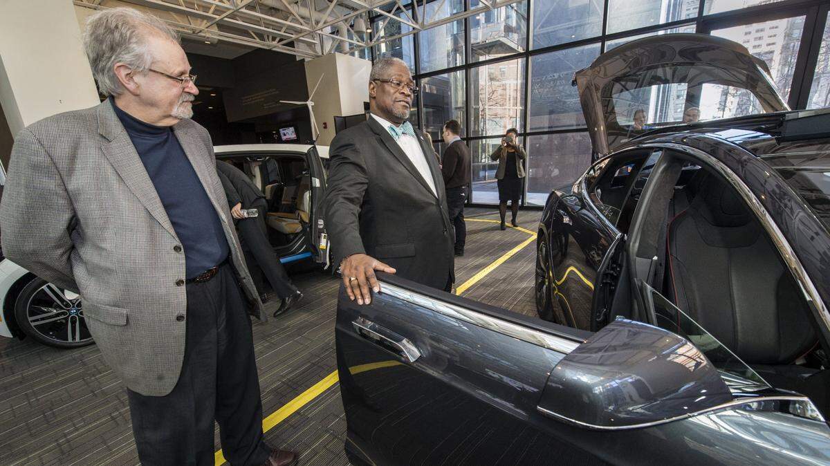 Dennis Murphey (left), chief environmental officer with Kansas City, and Kansas City Mayor Sly James look at an electric Tesla car after a news conference in 2015 at KCP&L’s Energy Center in downtown Kansas City.