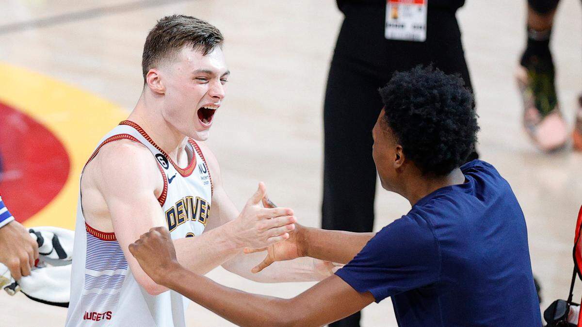 Denver Nuggets guard Christian Braun (0) celebrates after winning 2023 NBA Championship against the Miami Heat at Ball Arena on June 12, 2023.