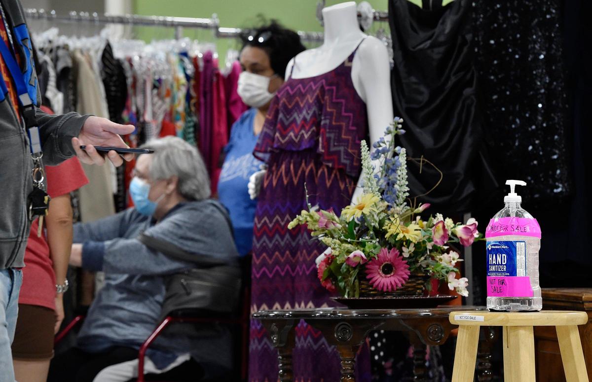 Brightly colored hand sanitizer bottles are placed throughout the Hillcrest Platte County thrift store in Kansas City.
