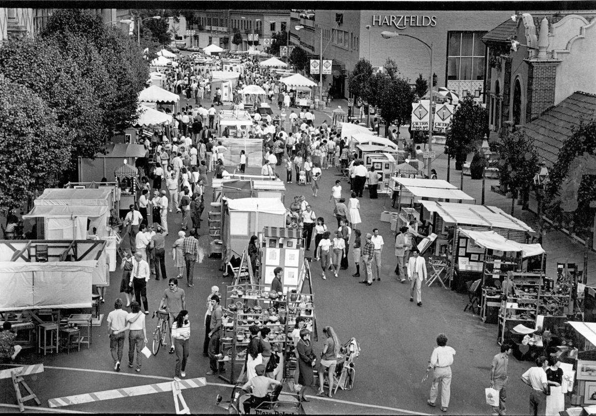 Crowds browse among rows of white tents at the 1984 Country Club Plaza Art Fair, where artists from across the country showcased their work. The annual event brings vibrant displays, live entertainment, and a festive atmosphere to the heart of Kansas City.
