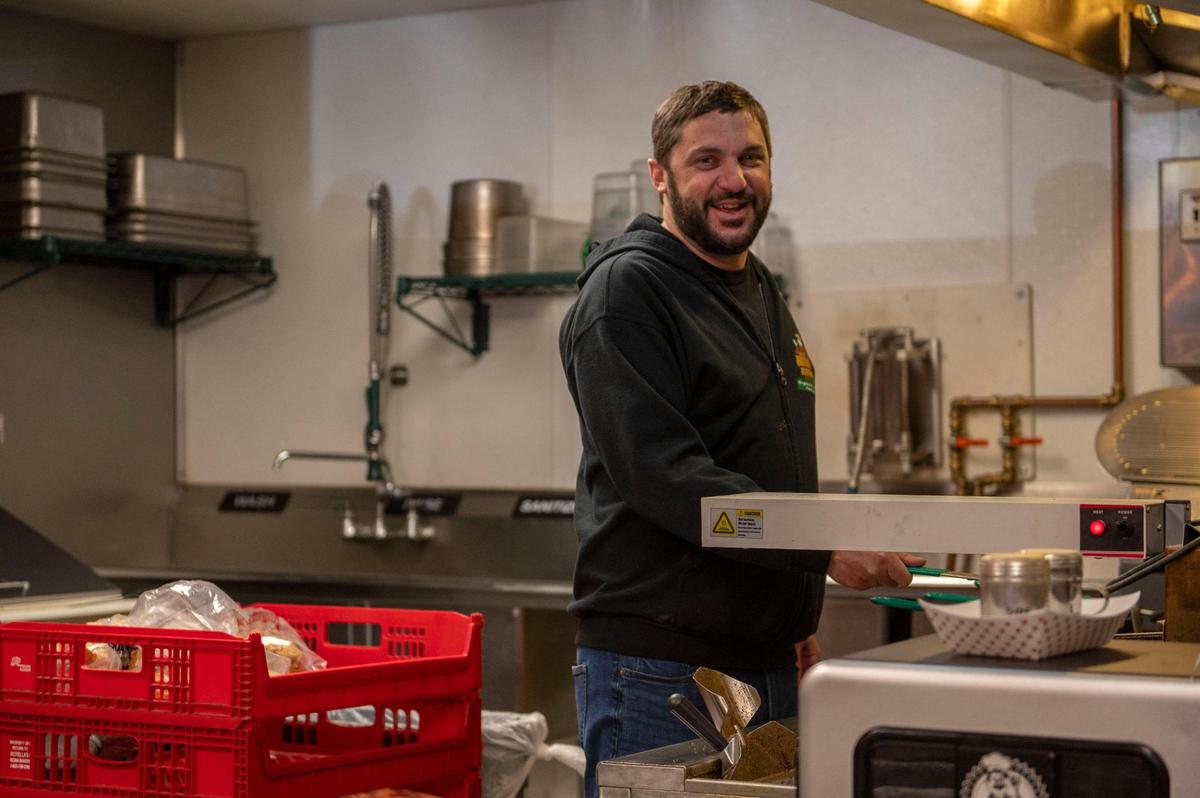 Kent Harrison, owner of Tay’s Cheesesteaks in North Kansas City, prepares to cook a batch of fries.