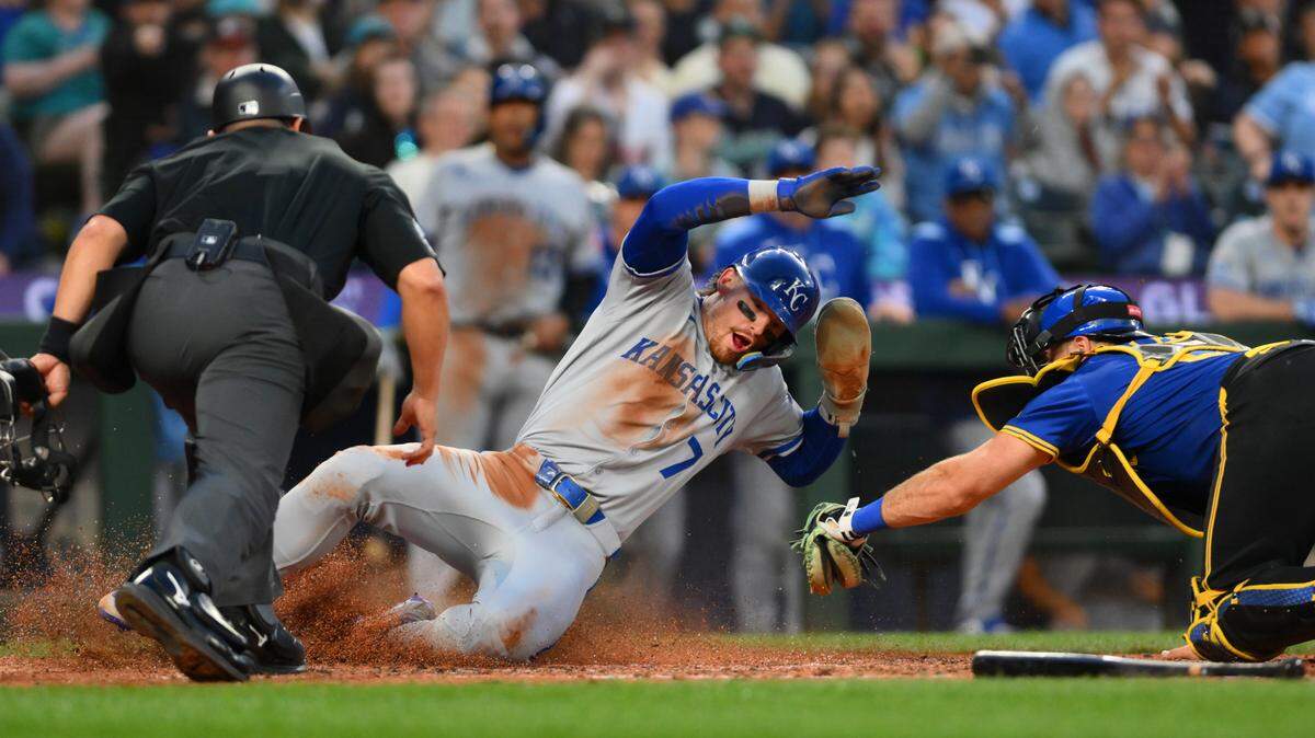 Kansas City Royals shortstop Bobby Witt Jr. (7) scores a run past Seattle Mariners catcher Cal Raleigh (29) during the seventh inning at T-Mobile Park on July 3, 2025.