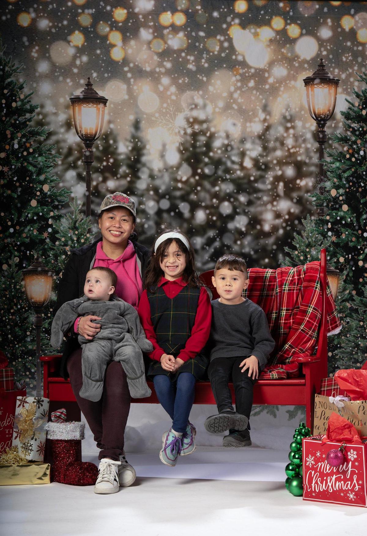 Haia Engler and her children Hazia Engler, Reese Engler and Hans Engler had their portrait taken at the Plaza Branch Library on Thursday, Dec. 12, 2024 in Kansas City.