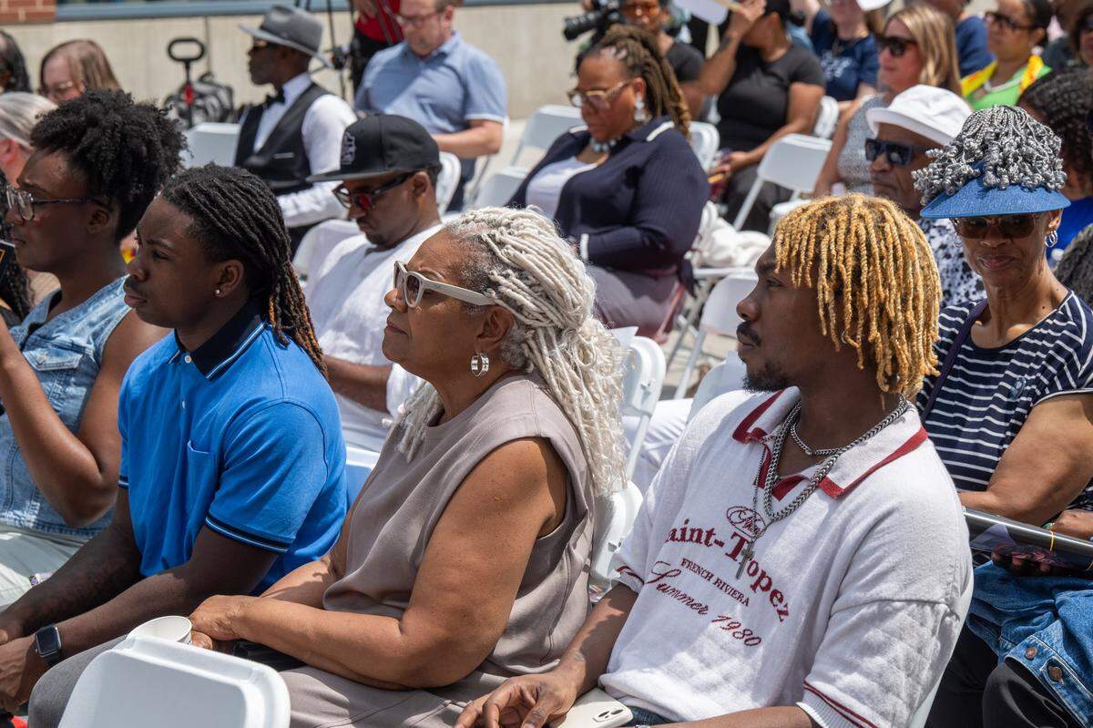 Community members listen to speakers at the re-opening of the pedestrian mall in the 18th & Vine Jazz District on Wednesday, May 27, 2026, in Kansas City.