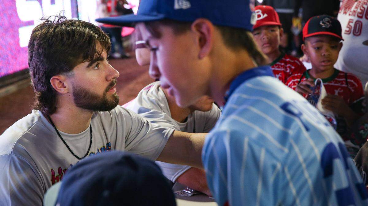 Kansas City Royals prospect Blake Mitchell, left, signs autographs for kids during an offseason visit to his hometown. Mitchell, a catcher, is from Sinton, Texas, near Corpus Christi.