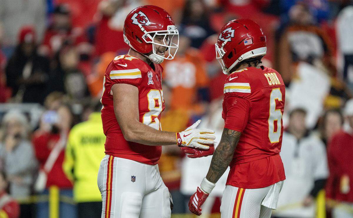 Kansas City Chiefs tight end Travis Kelce (87) greets Kansas City Chiefs safety Bryan Cook (6) during warms up the game against the Denver Broncos on Thursday, Dec. 25, 2025, at GEHA Field at Arrowhead Stadium.