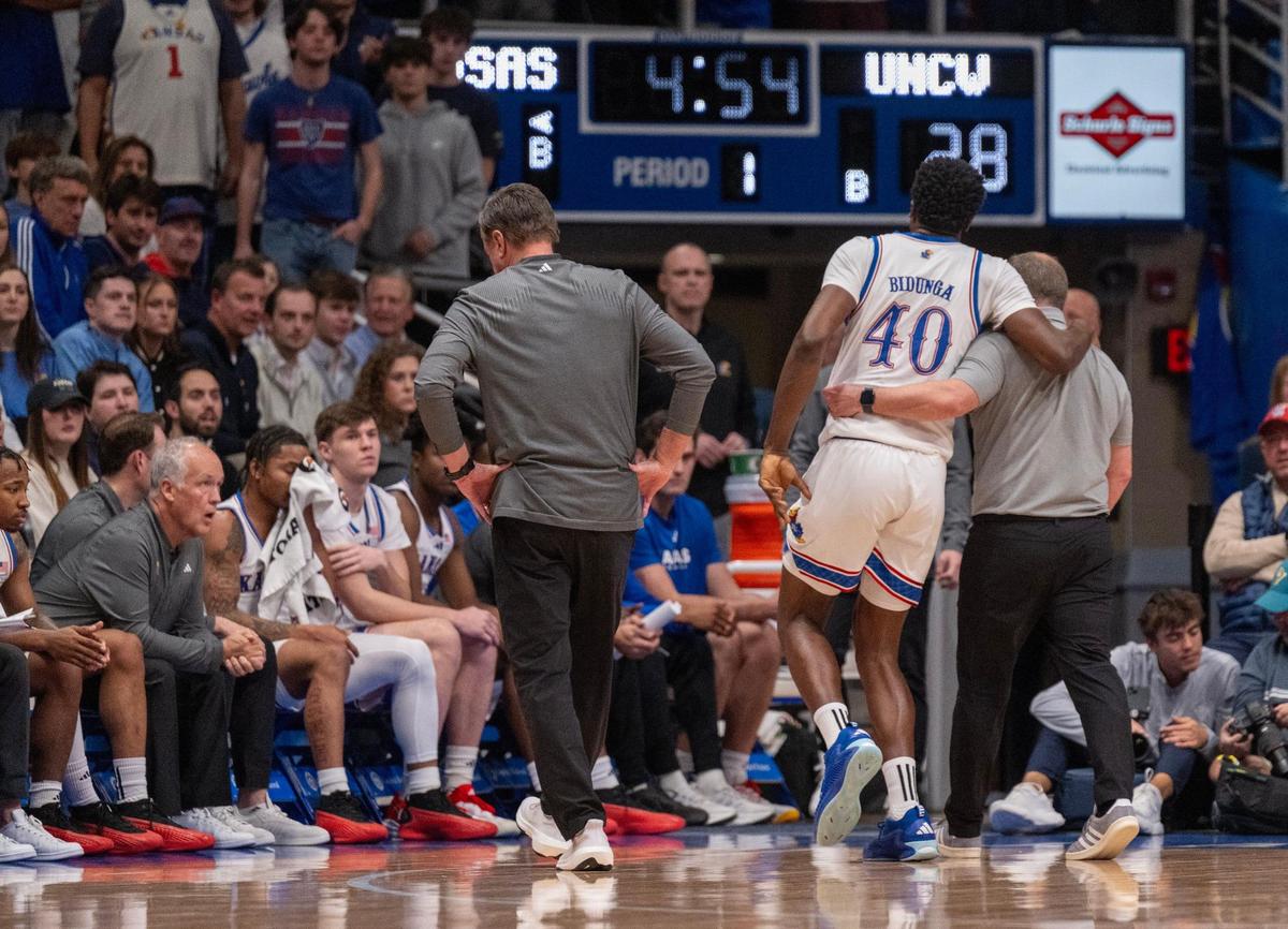 Kansas Jayhawks forward Flory Bidunga (40) is helped off the court in the first half against UNC Wilmington on Tuesday, Nov. 19, 2024, at Allen Fieldhouse.