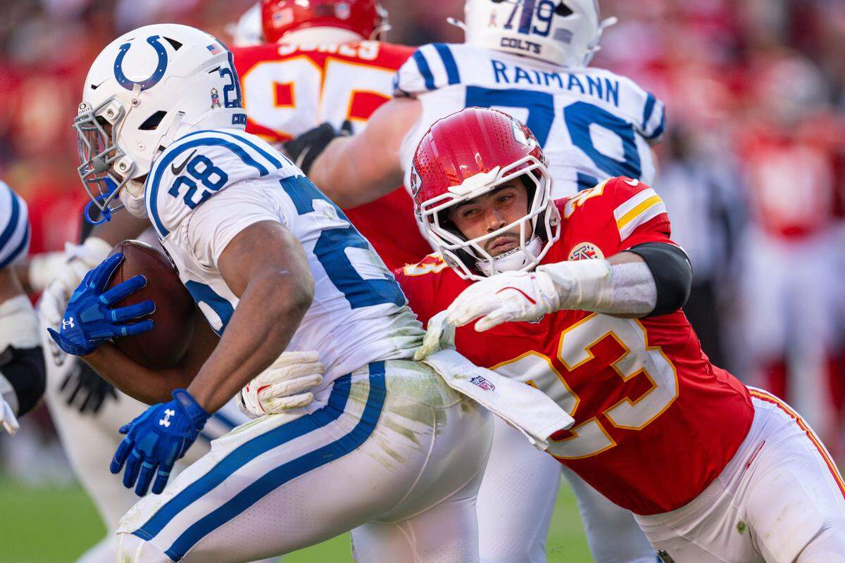 Kansas City Chiefs linebacker Drue Tranquill (23) makes a tackle for loss on Indianapolis Colts running back Jonathan Taylor (28) during the second half of the Chiefs game against the Indianapolis Colts on Sunday, November 23, 2025, at GEHA Field at Arrowhead Stadium.