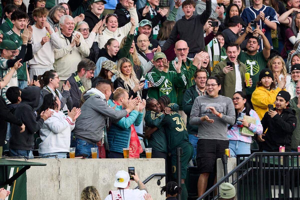 Timbers midfielder Santiago Moreno hugs his mother (at bottom-center of photo) after scoring against Sporting Kansas City during a Major League Soccer match at Providence Park in Portland, Oregon on Saturday, May 10, 2025.