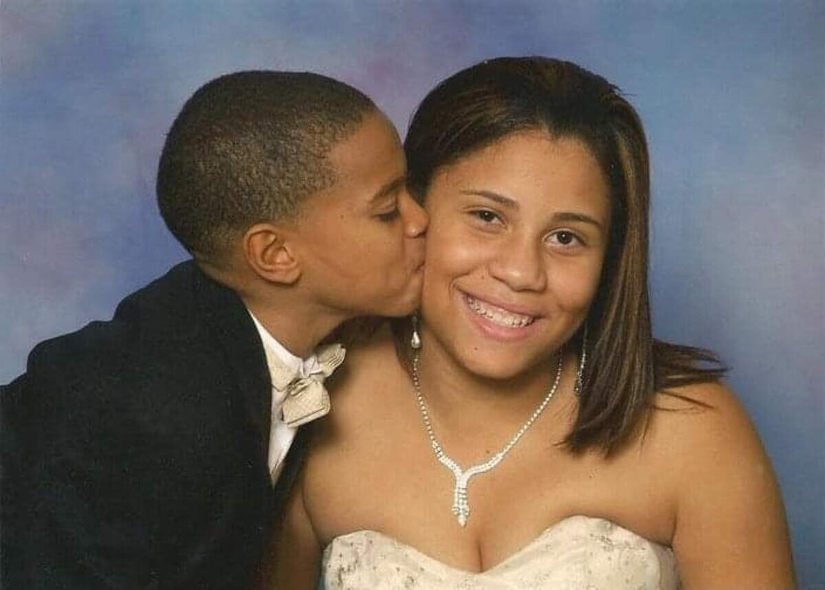 Adam “A.J.” Blackstock Jr., left, kisses his older sister Danielle Blackstock on the cheek during a childhood photograph.