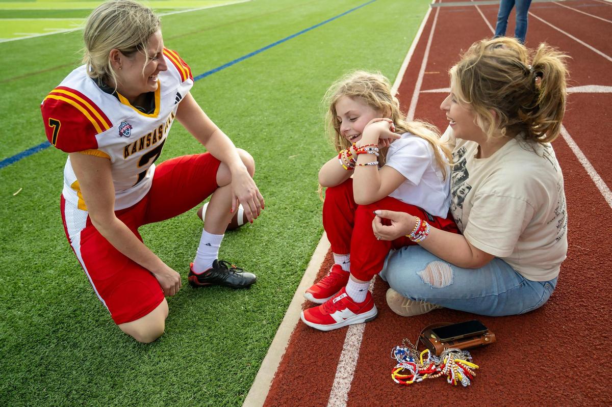 Kansas City Glory kicker/punter Sheila Sickau (7) greets special guests Elena Easley, 8, and her mother, Stephanie Easley, who traveled from Cambridge, Minnesota, to the team’s home opener on Saturday, March 29, 2025, at the Pembroke Hill School in Kansas City.