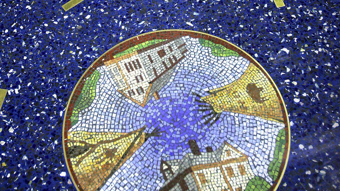 Two mosaic medallions are seen on the floor of Terminal B at Kansas City International Airport.