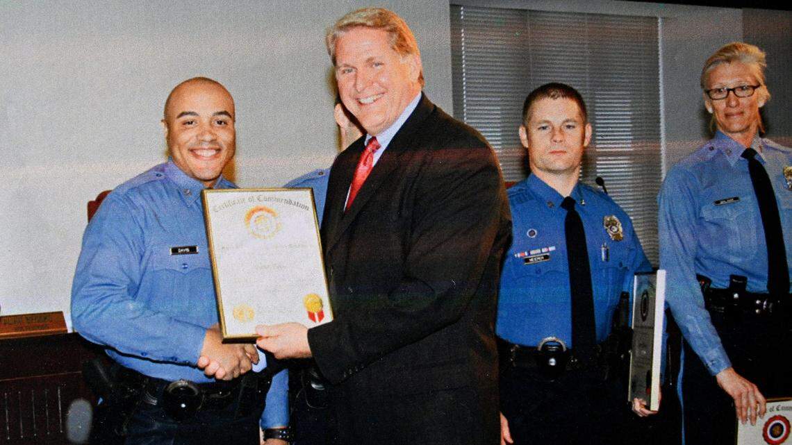 David Davis, who worked for KCPD from 2004 to 2018, receives a certificate of commendation from former Kansas City Police Chief Jim Corwin. Davis said he was regularly called “boy” as a civilian employee and as an officer was called a racial slur by a sergeant.
