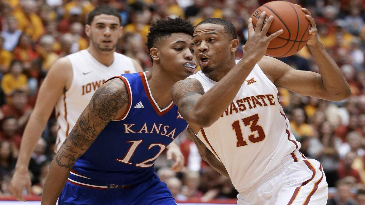 Iowa State guard Bryce Dejean-Jones, right, drives past Kansas guard Kelly Oubre Jr. during the first half of an NCAA college basketball game, Saturday, Jan. 17, 2015, in Ames, Iowa. 