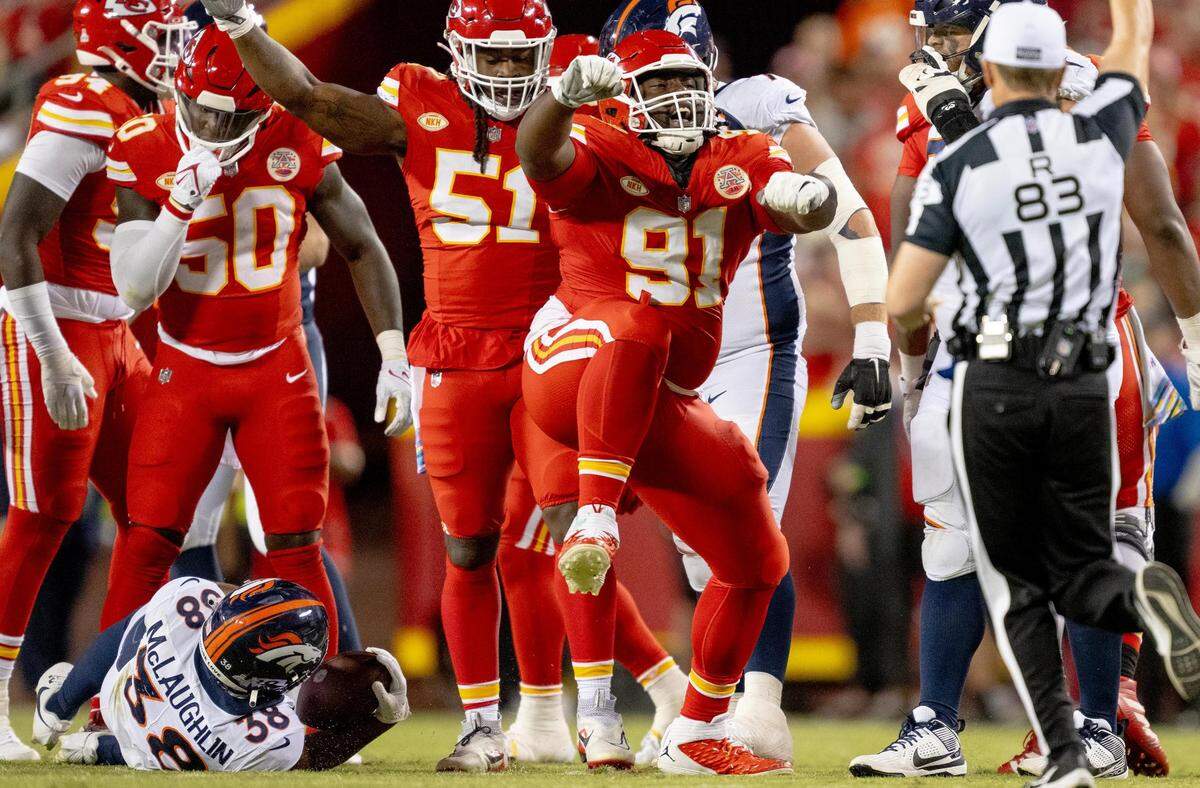 Kansas City Chiefs defensive tackle Derrick Nnadi (91) celebrates a tackle on Denver Broncos running back Jaleel McLaughlin (38) during an NFL football game at GEHA Field at Arrowhead Stadium on Thursday, Oct. 12, 2023, in Kansas City.