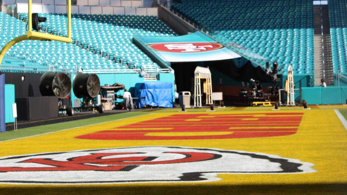 The Chiefs logo is painted onto an end zone of the Hard Rock Stadium turf as crews prepare for the Super Bowl.