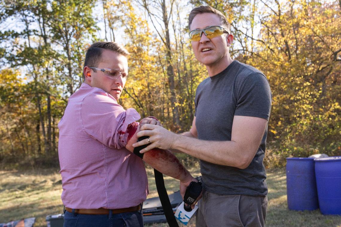 Missouri Democratic candidate for U.S. Senate Lucas Kunce applies first aid to KSHB 41 reporter Ryan Gamboa after Gamboa was struck by ricochet from a bullet fragment shot from a gun handled by Kunce during a sport shooting campaign event Tuesday, Oct. 22, 2024 in Holt, Missouri.