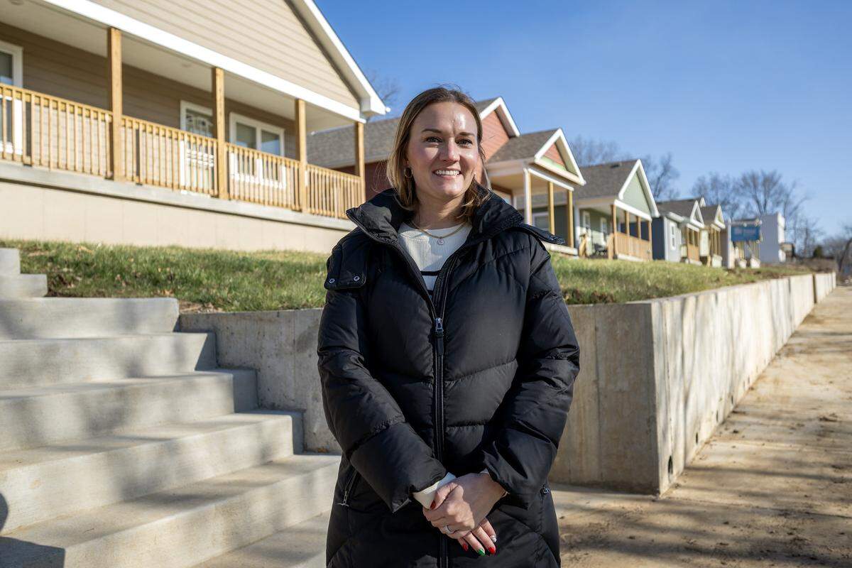 Lindsay Hicks, president and CEO of Habitat for Humanity of Kansas City, stands for a portrait near newly built homes in the Lykins neighborhood on Tuesday, Dec. 16, 2025.
