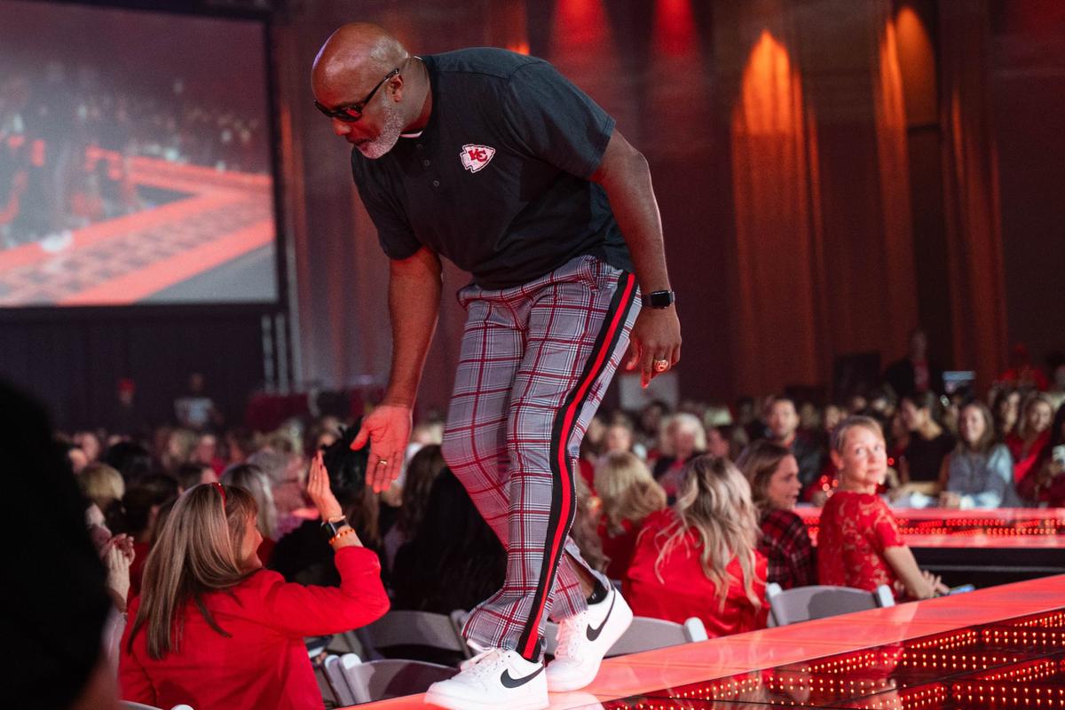 Former Kansas City Chiefs player Keith Cash high fives a fan on the runway at the 13th Annual Chiefs Style Lounge Tuesday at The LEX in downtown Kansas City.