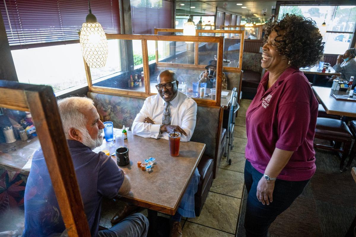 The Star’s Vahe Gregorian, left, and Bob Kendrick, president of the Negro Leagues Baseball Museum, share a laugh with Denise Ward, founder of Niecie’s Restaurant, who stopped by their table during breakfast.