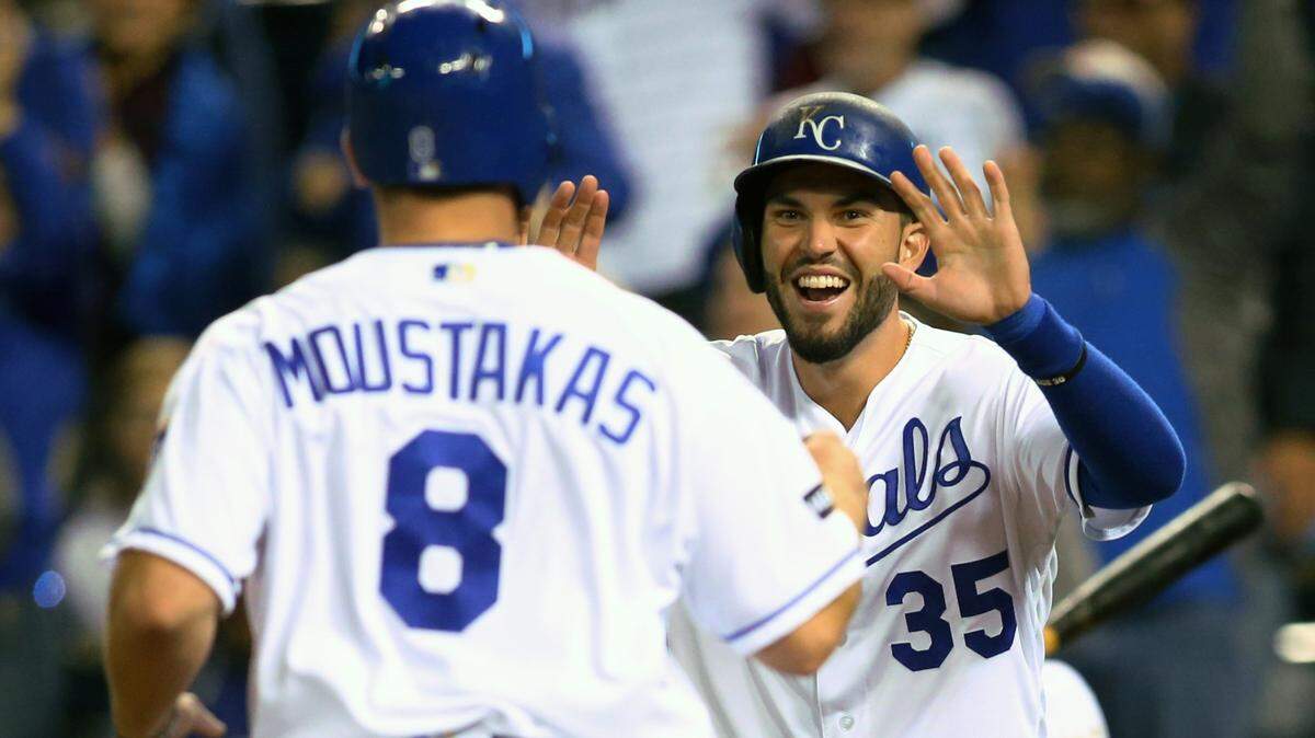 Kansas City Royals third baseman Mike Moustakas (8) is congratulated by designated hitter Eric Hosmer (35) after scoring against the Detroit Tigers in the eighth inning at Kauffman Stadium on Sept. 27, 2017.