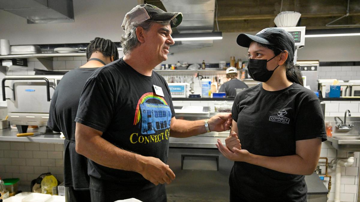 Randy Ross, left, talked with Samantha Rivas, 19, as they were worked recently at Connect Cafe, a coffee shop in Kansas City, Kansas, that employs and trains youth who have aged out of the foster care system.