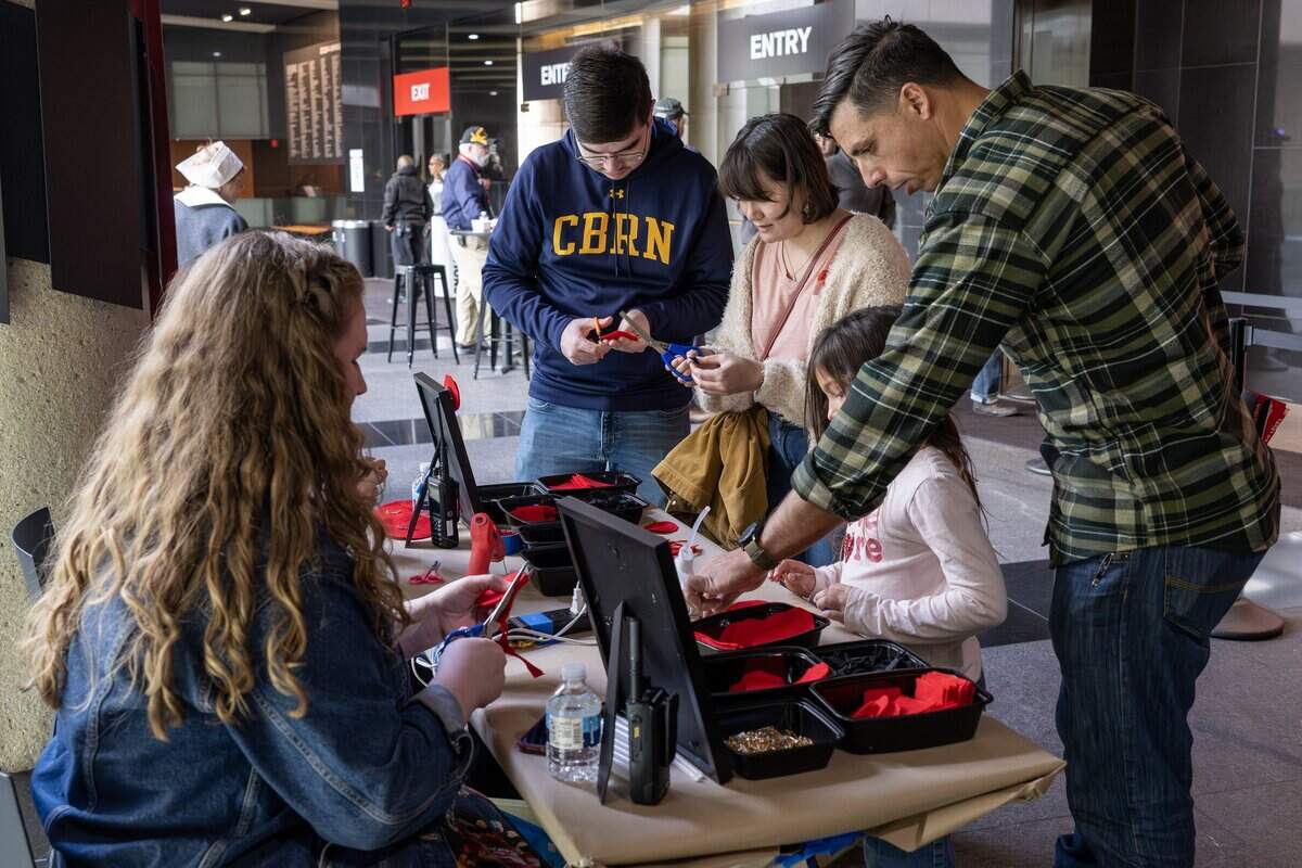 Visitors stop by the craft booth to make felt poppy pins in honor of Veterans Day at the National WWI Museum and Memorial on Tuesday, Nov. 11, 2025.