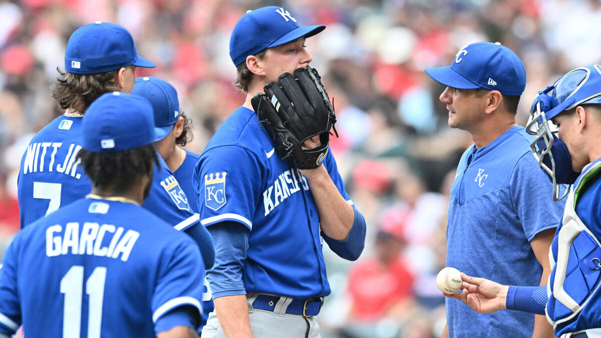 Kansas City Royals starting pitcher Brady Singer (51) talks with pitching coach Brian Sweeney (85) during the second inning against the Cleveland Guardians at Progressive Field on July 8, 2023.