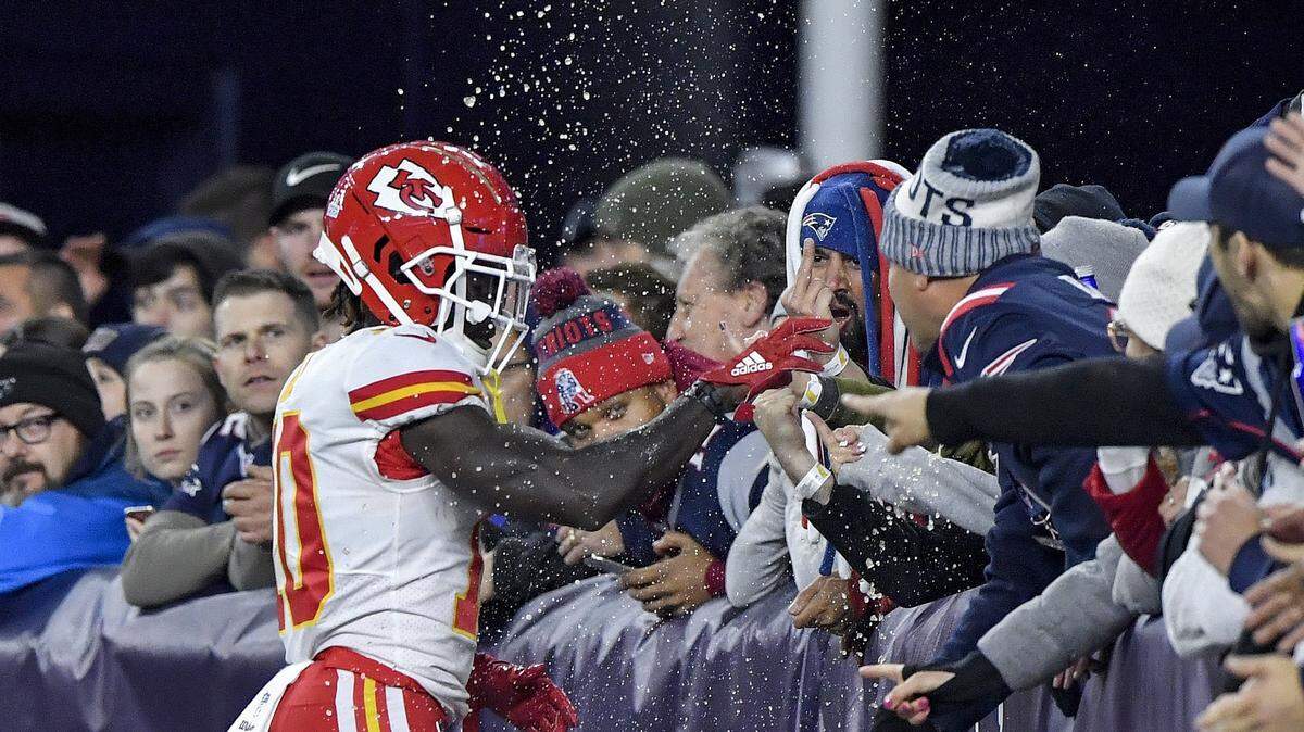 Chiefs wide receiver Tyreek Hill gets doused with beer by Patriots fans after scoring a fourth-quarter touchdown during Sunday’s game in New England.