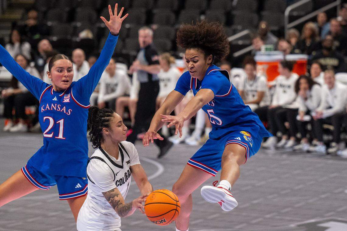 Kansas Jayhawks forward Jaliya Davis (25) and guard Elle Evans (21) attempt to deflect an inbound pass in the second half of KU’s second-round game at the Big 12 Women's Basketball Tournament on Thursday, March 5, 2026, at T-Mobile Center in Kansas City.