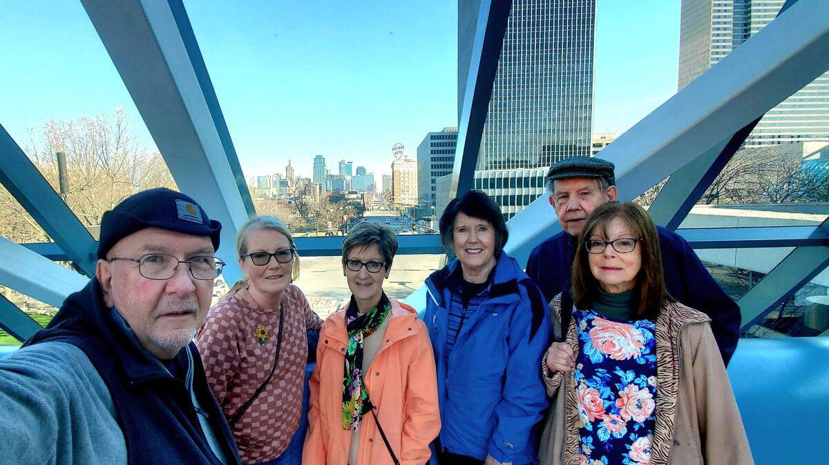 With a view of Grand Avenue and downtown behind them, neighborhood friends pause on the Crown Center Link during one of about 300 weekly hikes they have experienced in the last six years. From left: Steele Tollison, Elise Ray, Chris Chitwood, Ann Keary, Charles Hammer and Kathleen Connors.