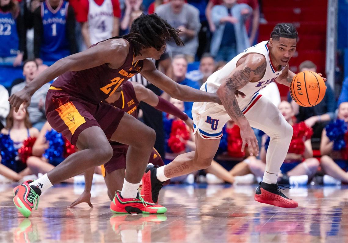 Kansas Jayhawks guard Shakeel Moore (No. 0, right) handles the ball as Arizona State Sun Devils guard Alston Mason (No. 1) and forward Jayden Quaintance (No. 21) defend during a college basketball game at Allen Fieldhouse on Wednesday, Jan. 8, 2025, in Lawrence, Kansas.