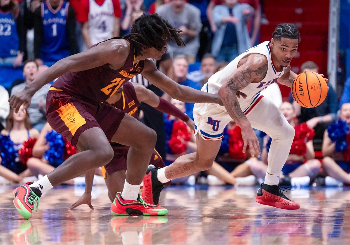 Kansas Jayhawks guard Shakeel Moore (No. 0, right) handles the ball as Arizona State Sun Devils guard Alston Mason (No. 1) and forward Jayden Quaintance (No. 21) defend during a college basketball game at Allen Fieldhouse on Wednesday, Jan. 8, 2025, in Lawrence, Kansas.
